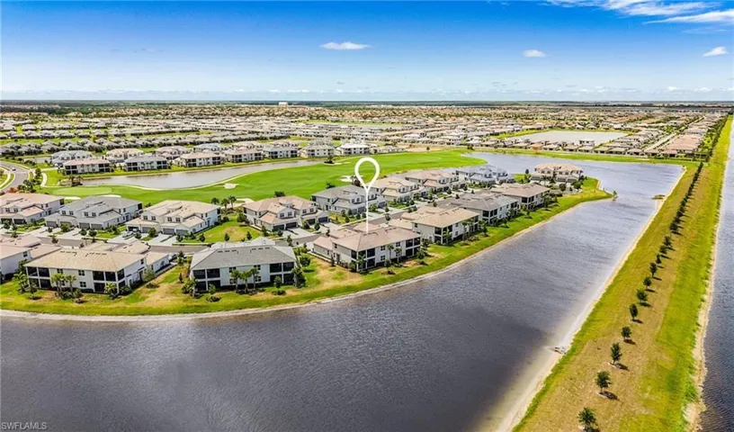 Aerial view of a residential community featuring waterways, green spaces, and a golf course