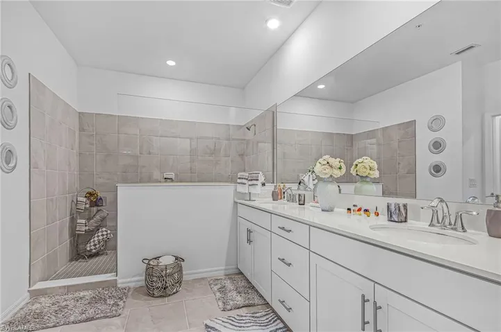 Dual vanity with white cabinetry and integrated sinks