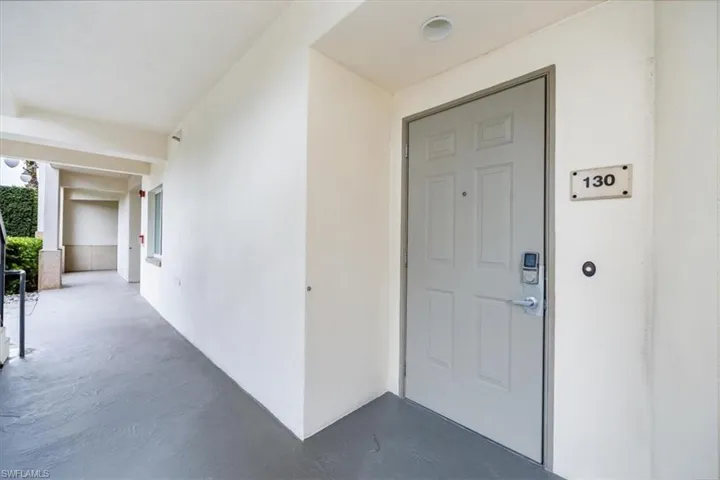 View of exterior entry door. Door has secured electronic key bad for guests