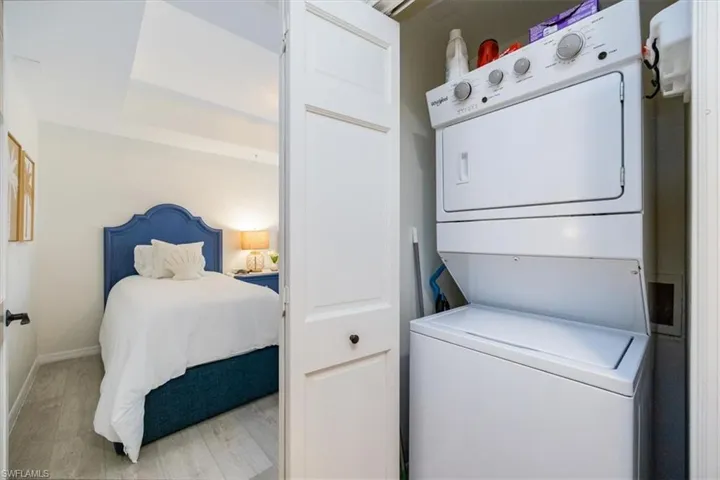Clothes washing area featuring stacked washer and dryer right in the condo