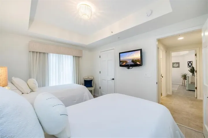Guest bedroom with two oversized twin beds and closet