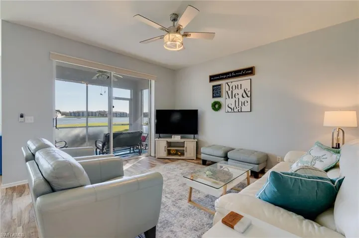 Living area with a ceiling fan and wood finished floors