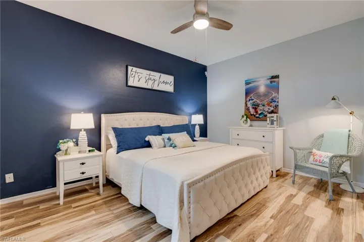 Bedroom with light wood finished floors and ceiling fan