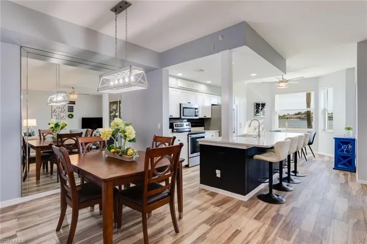 Dining area featuring a ceiling fan, light wood-style flooring, and recessed lighting