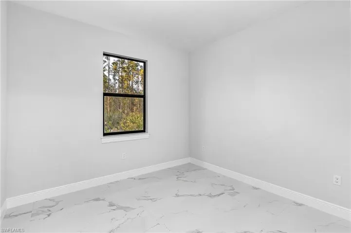 Spare room featuring light tile floors