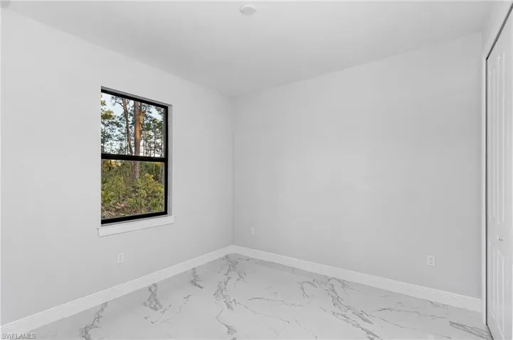 Empty room featuring light tile floors