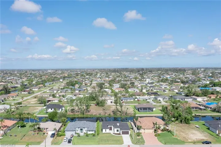 Aerial perspective of suburban area with a nearby body of water