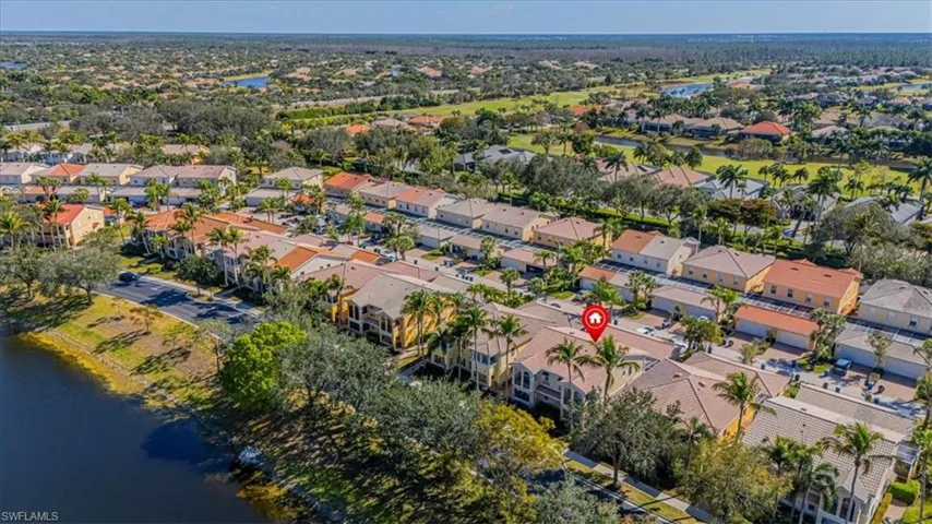 Aerial view of property and surrounding area with a nearby body of water and nearby suburban area