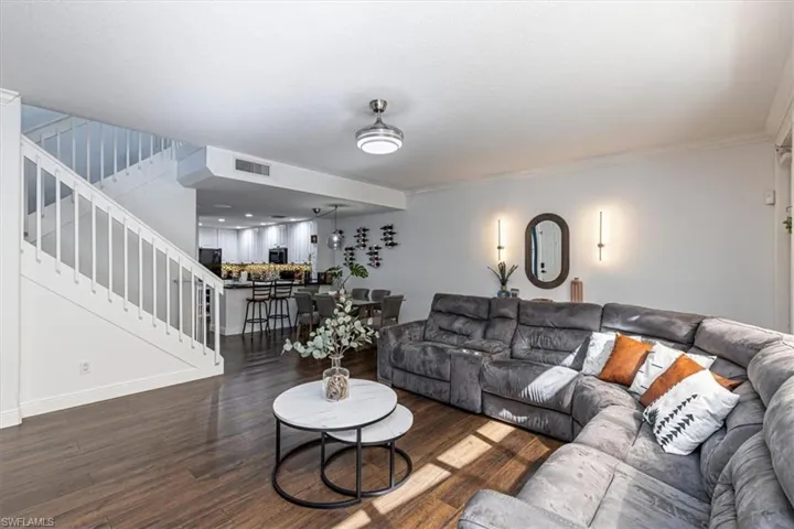 Living area featuring wood finished floors and ornamental molding
