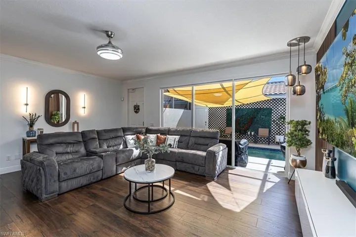 Living area with crown molding and hardwood / wood-style flooring
