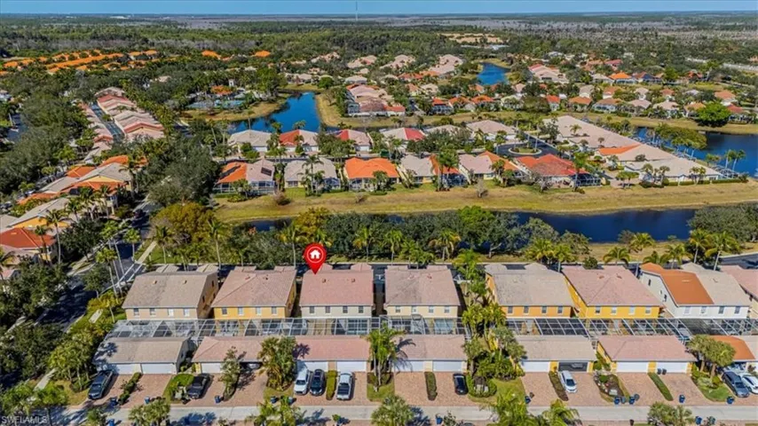 Aerial view of property and surrounding area with nearby suburban area