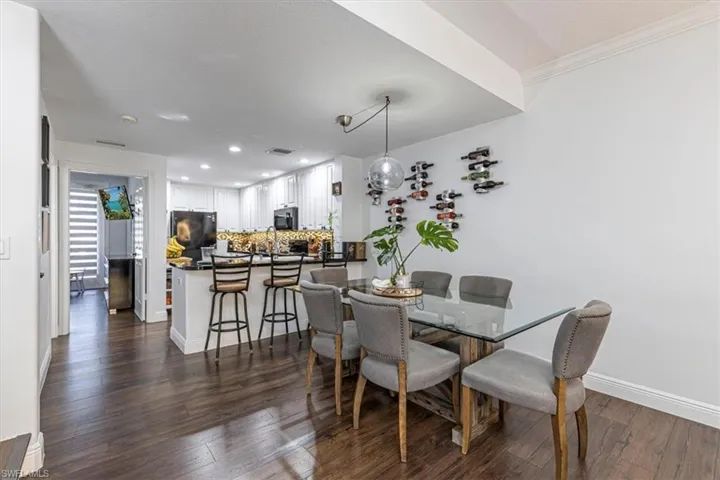 Dining area featuring dark wood-style flooring and recessed lighting
