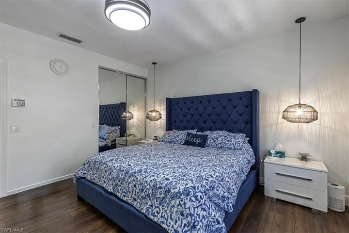 Bedroom featuring dark wood-style floors and a closet