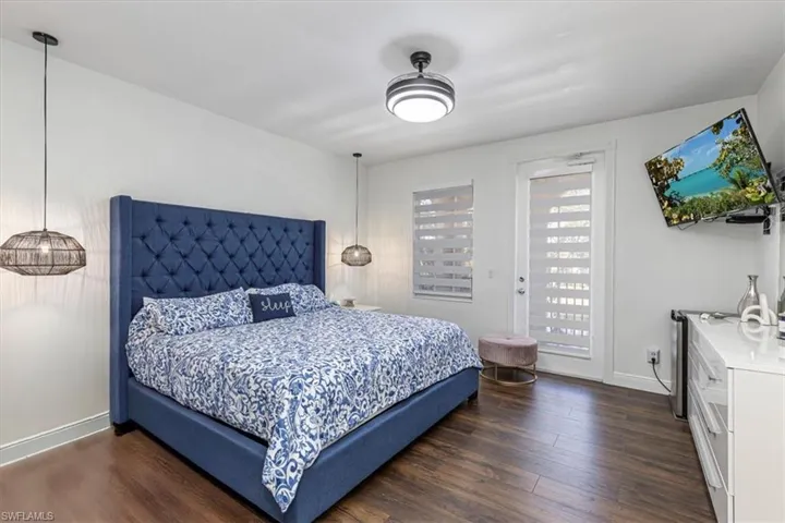 Bedroom with dark wood-style flooring and access to exterior