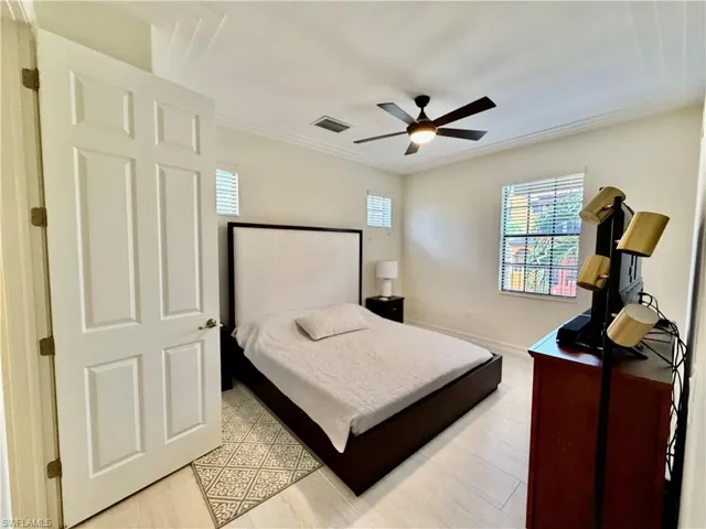 Bedroom featuring a ceiling fan and crown molding