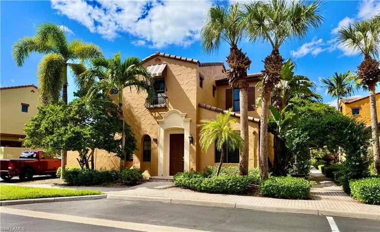 Mediterranean / spanish house with a balcony, stucco siding, and a tile roof