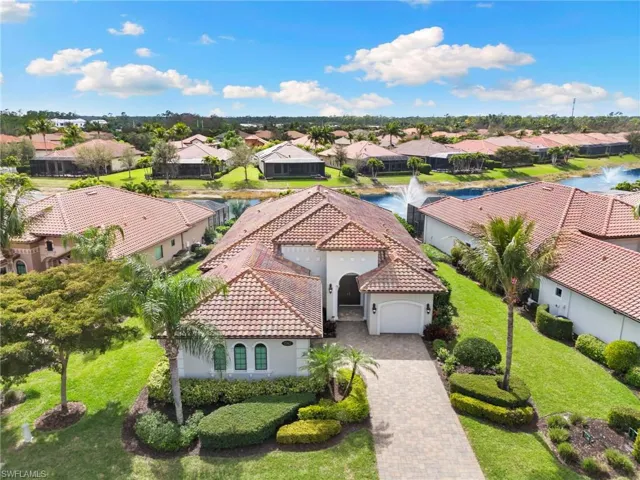Aerial view of residential area featuring a nearby body of water