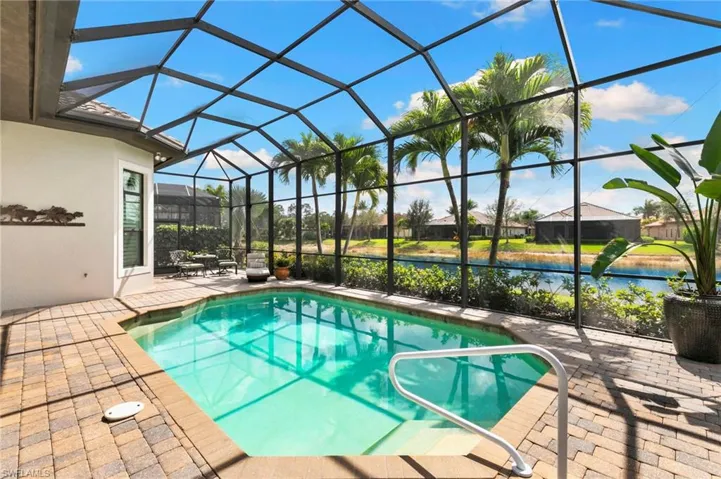 Swimming pool featuring a patio area, a sunroom, and a lanai