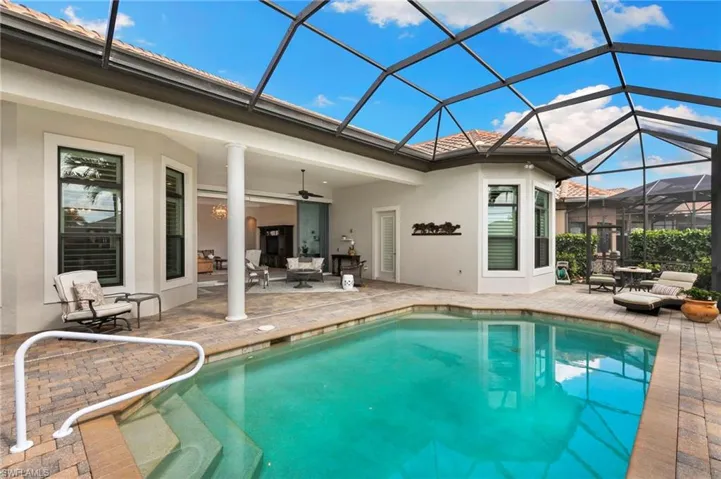 Outdoor pool with a sunroom, a patio, a lanai, and outdoor seating