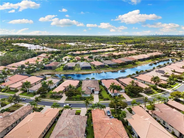 Aerial view of residential area featuring a nearby body of water