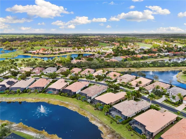 Aerial perspective of suburban area featuring a large body of water