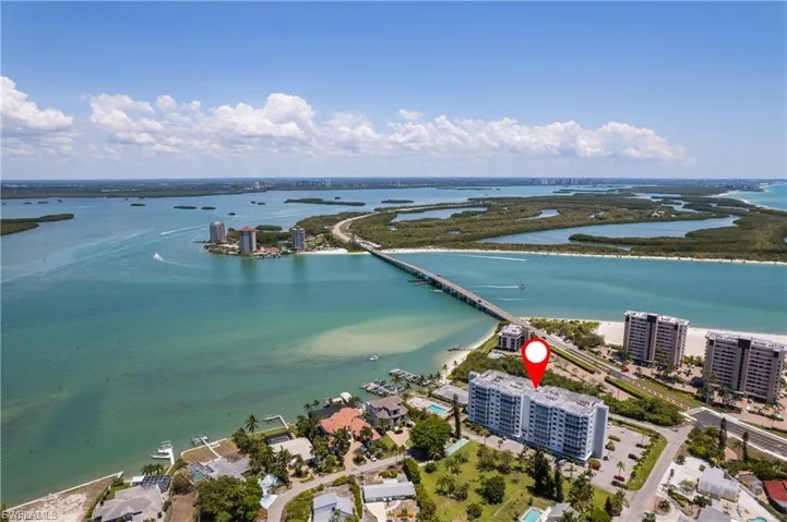 Aerial perspective highlighting waterfront proximity, surrounding islands, a multi-story building, and a bridge structure