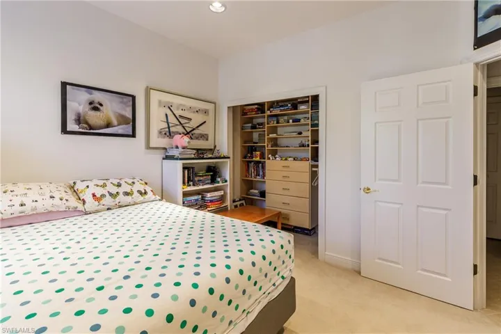 Bedroom featuring light colored carpet and a closet