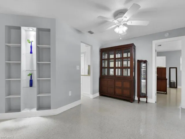 Entryway with ceiling fan and a textured ceiling