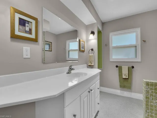Bathroom with vanity with extensive cabinet space