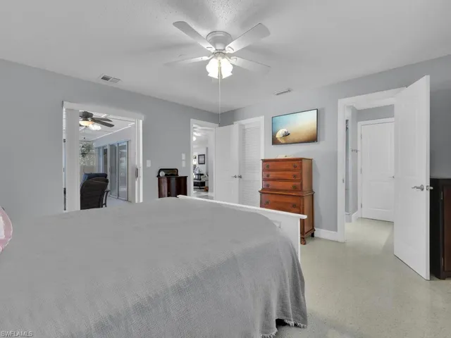 Bedroom featuring access to outside, a textured ceiling, and ceiling fan