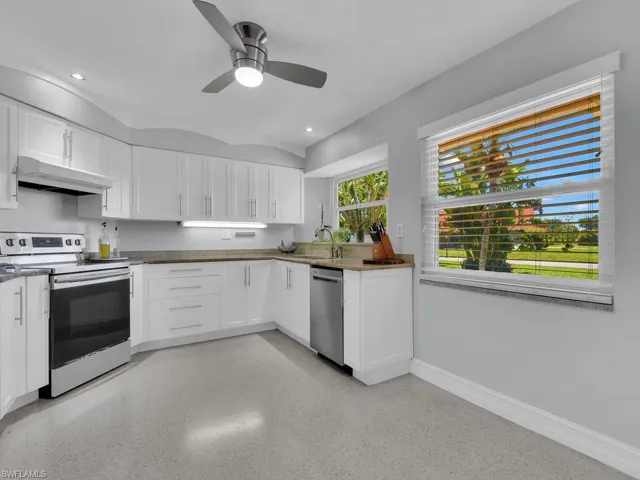 Kitchen featuring white cabinets, ceiling fan, electric range, stainless steel dishwasher, and sink