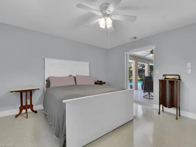 Bedroom featuring ceiling fan, a textured ceiling, and access to outside