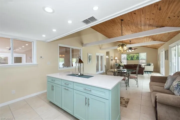 Kitchen featuring open floor plan, a chandelier, light tile patterned floors, recessed lighting, and wood ceiling