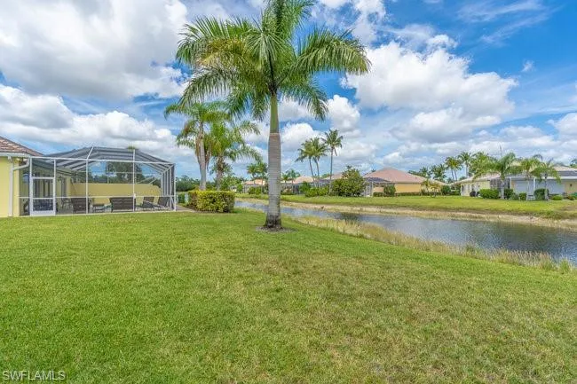 View of yard with a water view and a lanai