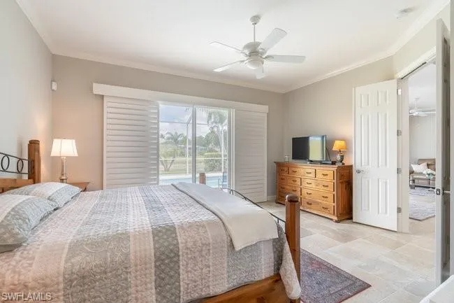 Bedroom with ceiling fan, access to exterior, and crown molding