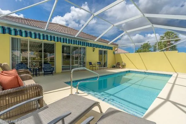 View of pool with a lanai, a patio area, and an outdoor hangout area