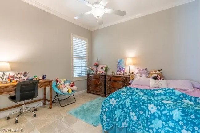 Tiled bedroom featuring ceiling fan and ornamental molding