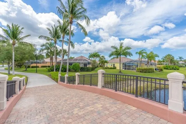 View of community featuring a yard and a water view