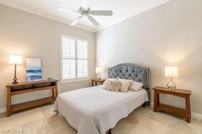 Bedroom with ceiling fan and crown molding
