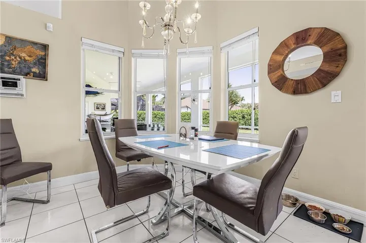 Dining area featuring a chandelier and light tile patterned flooring