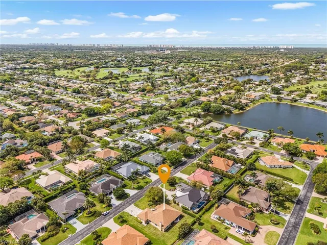 Aerial view of residential area featuring a nearby body of water
