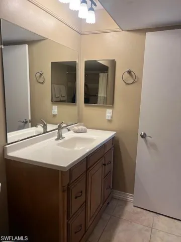 Bathroom featuring vanity and light tile patterned flooring