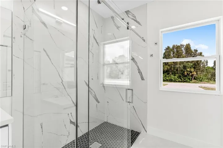 Bathroom with walk in shower and vanity