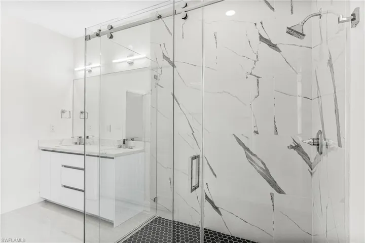 Bathroom with vanity and a shower with shower door