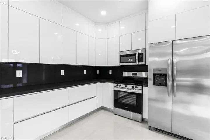 Kitchen with stainless steel appliances and white cabinetry