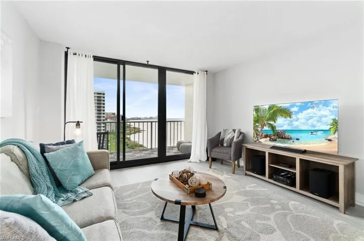 Living area featuring floor to ceiling windows and wood finished floors
