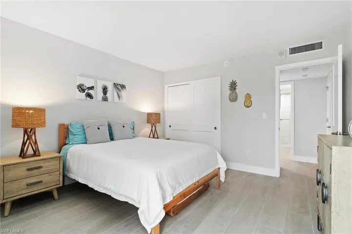 Bedroom with a closet and wood finish floors