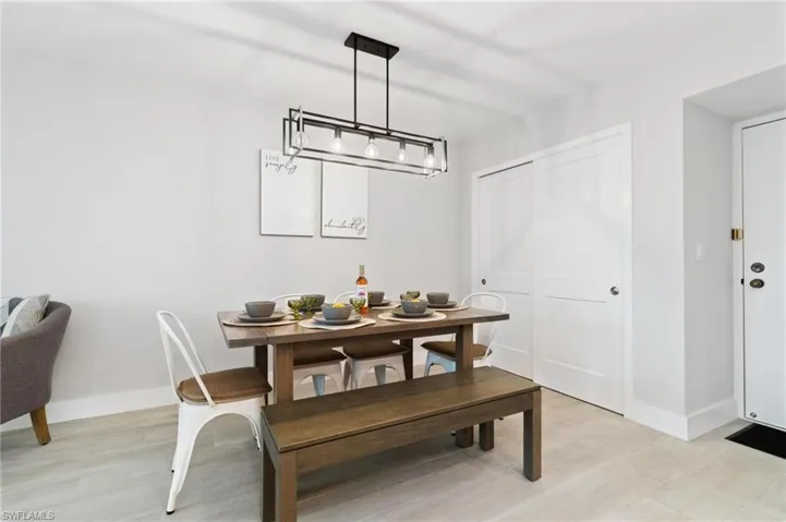 Dining room with light wood-style floors and baseboards