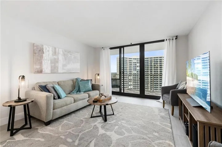 Living room featuring expansive windows and light wood-style flooring