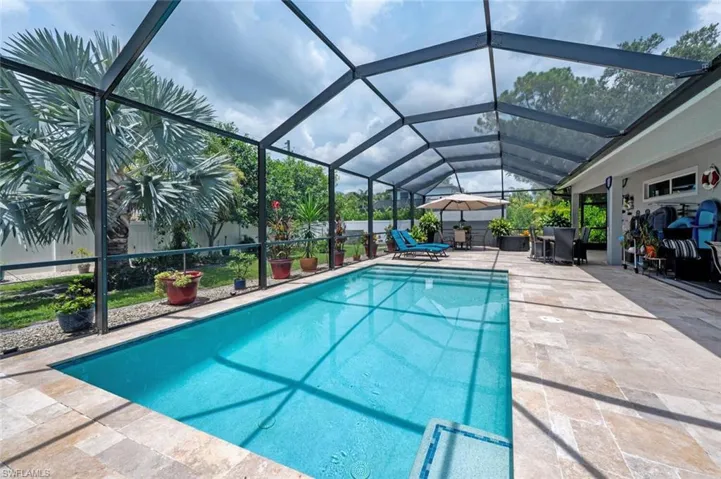 Swimming pool featuring a patio area and a lanai